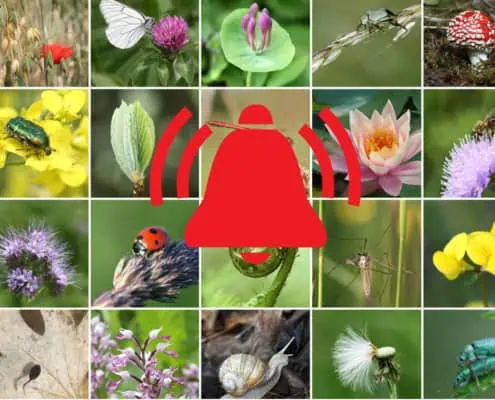 Alarm sign in front of images of animals and plants