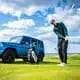 Golfer in front of a Mercedes